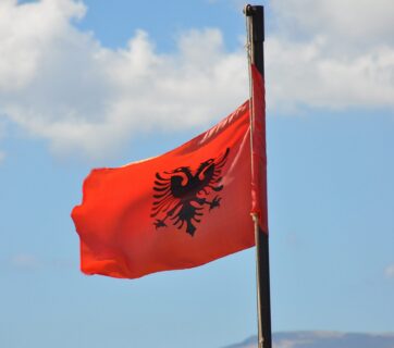 Die albanische Flagge vor dem blauen Himmel